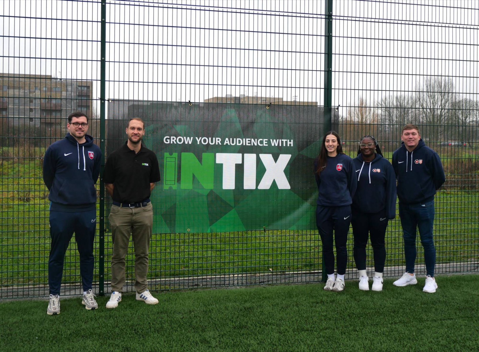 INTIX with Middlesex FA staff beside an INTIX banner