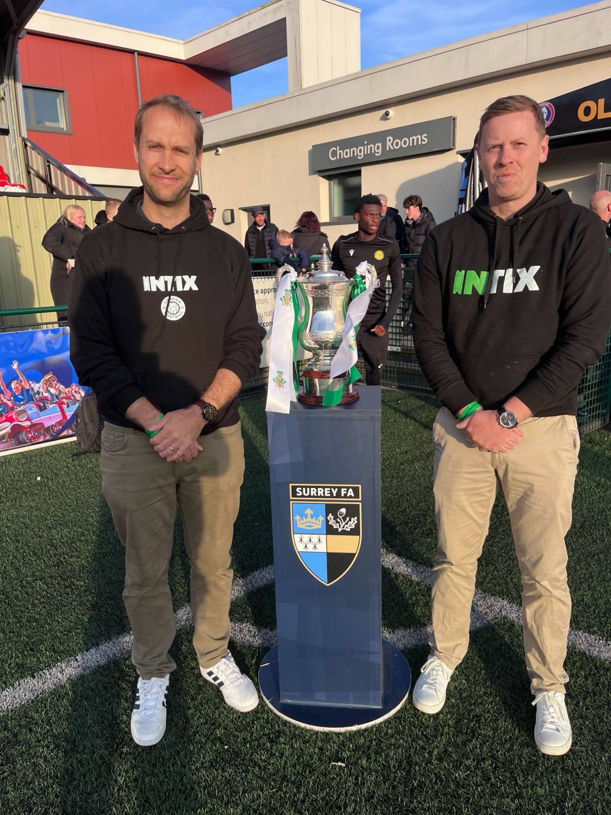The INTIX team beside the Surrey FA cup trophy on final day