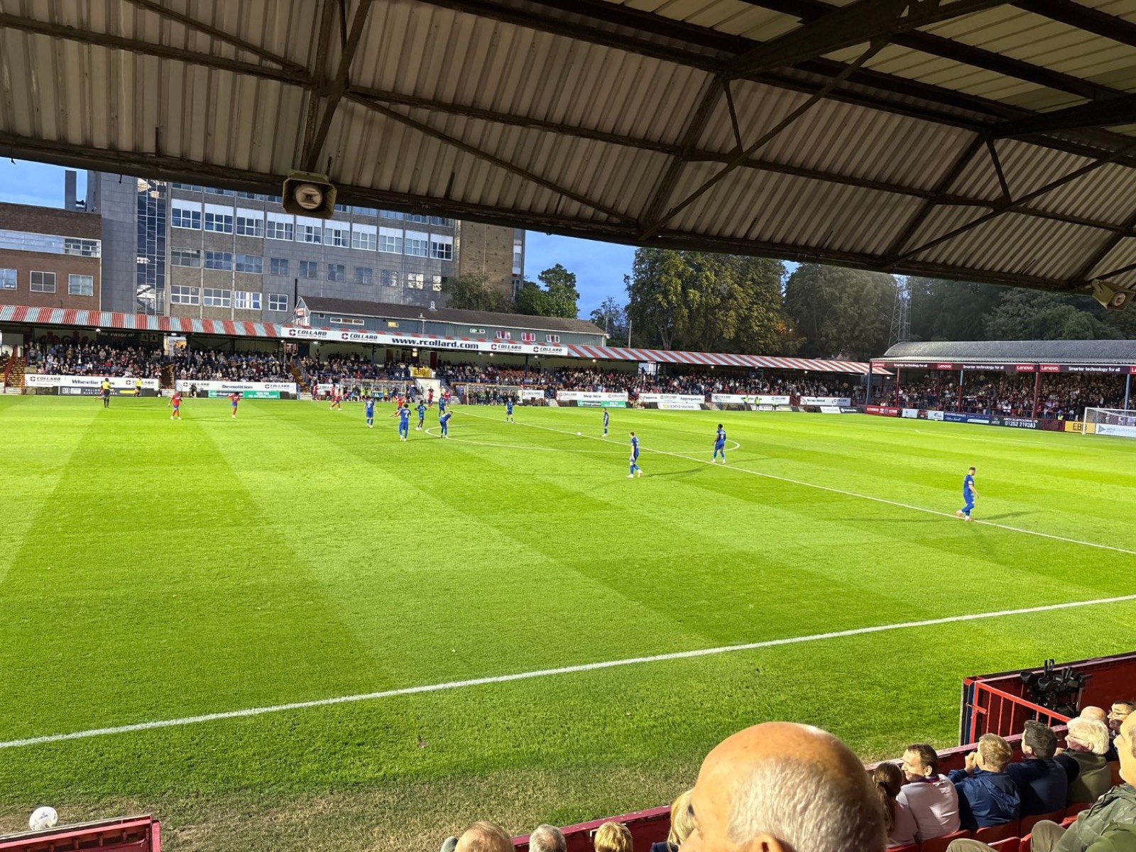 Evening match at an English football ground, seen from the covered terrace
